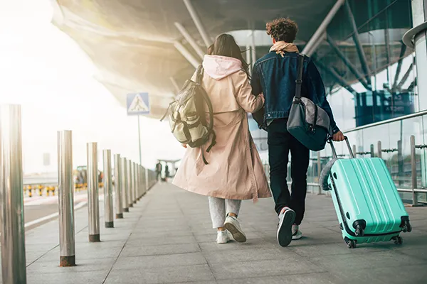 Couple travelling with a suitcase