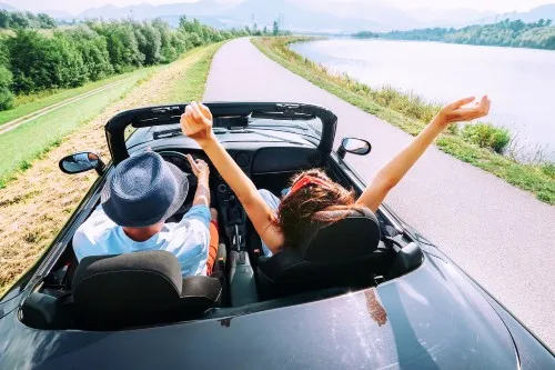 People driving a car in a rural setting