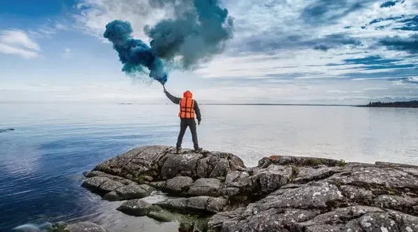 Person with a smoke flare outside