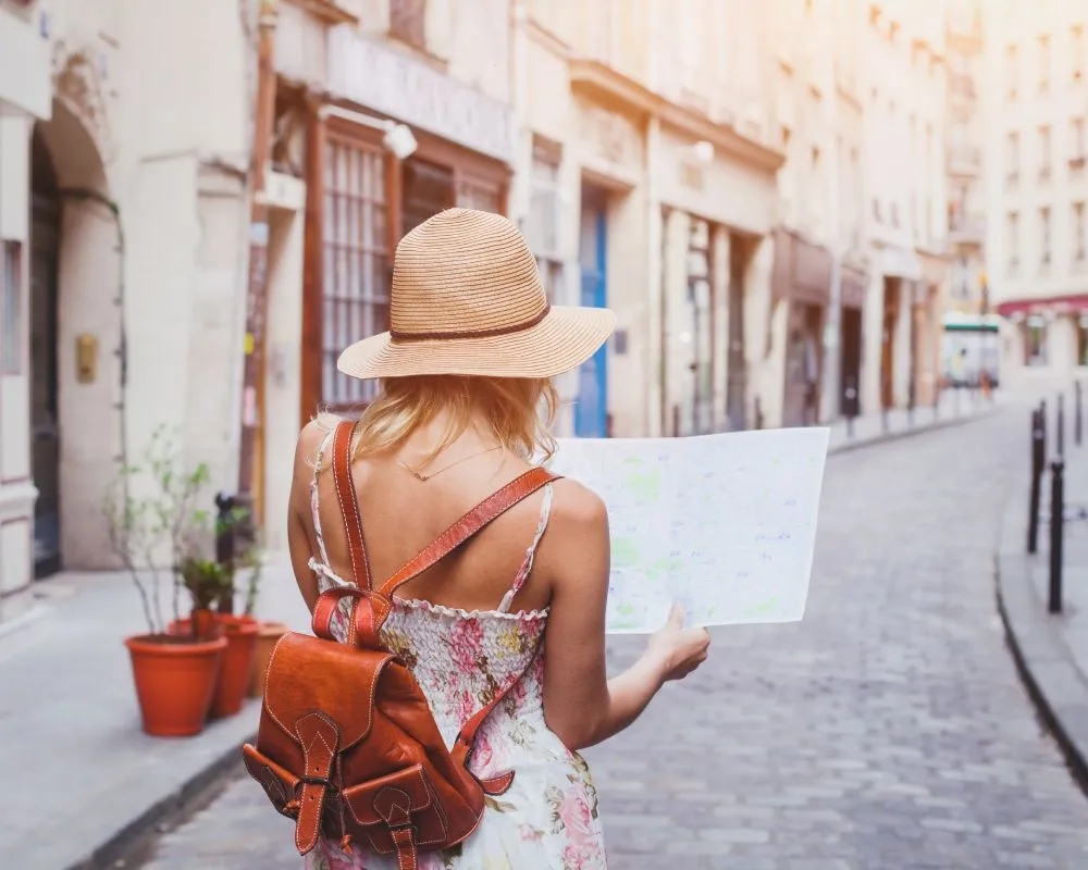 A tourist wandering a city with a map